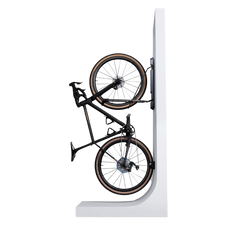 A black bike hanging in a Steadyrack bike rack on a white wall stand.