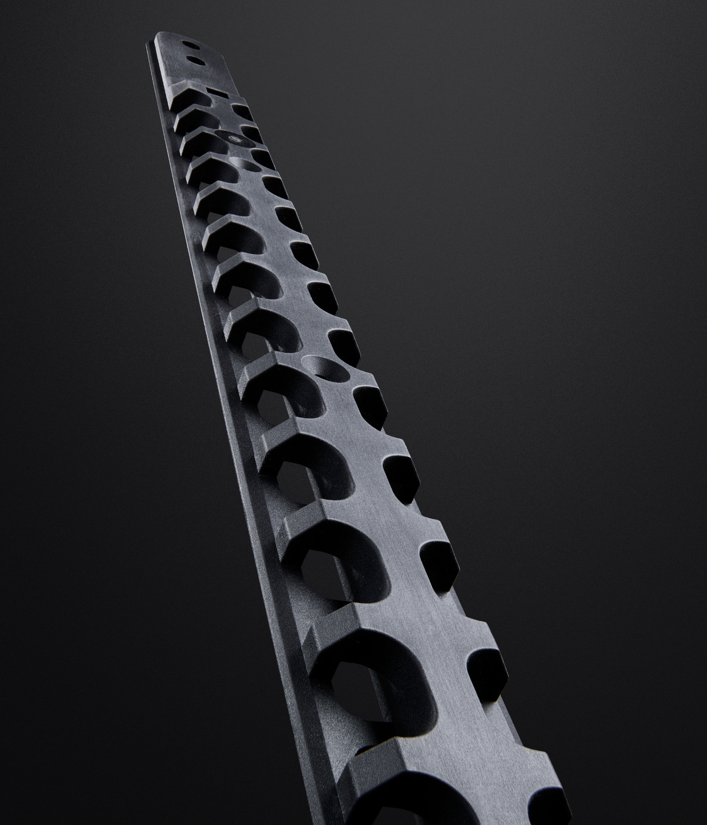 A black metal GearMate spine on a dark grey background.