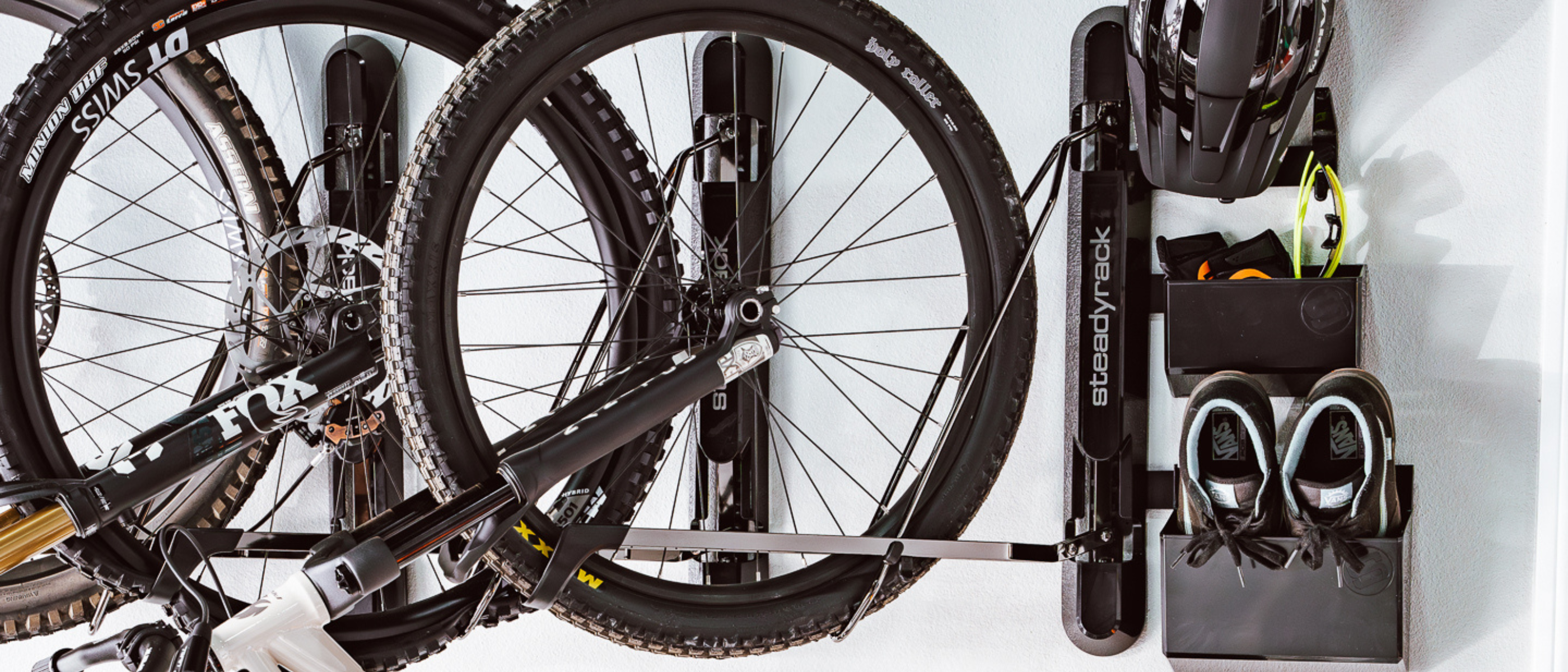 Bicycle mounted on a wall rack with tools attached, on a white background